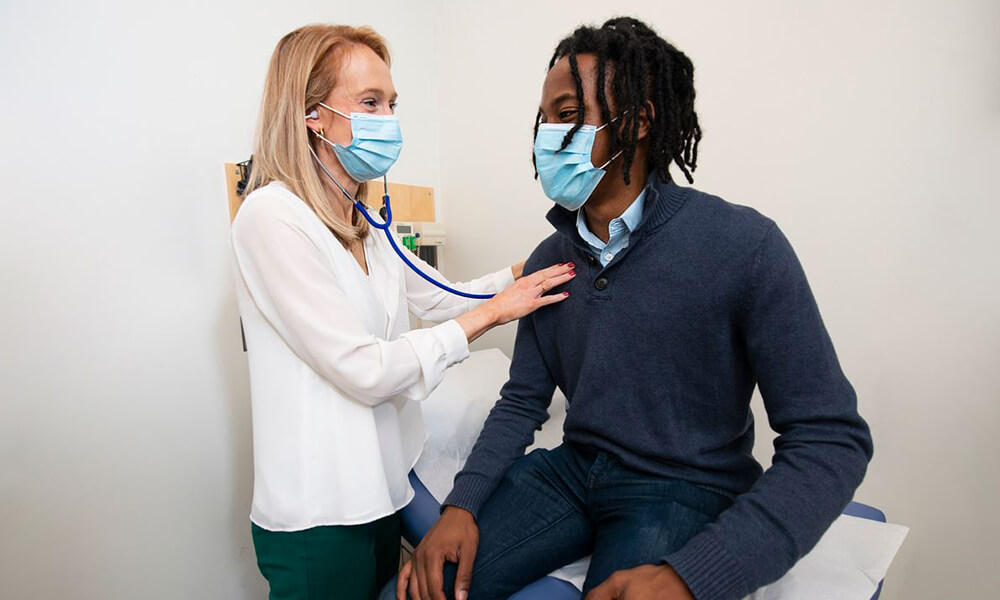 A smiling patient is attended to by a nurse A smiling patient is attended to by a nurse