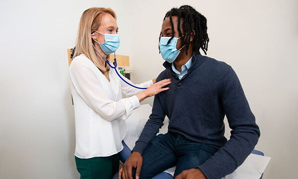 A smiling patient is attended to by a nurse A smiling patient is attended to by a nurse