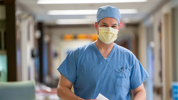 Clinicians consult each other in a hallway Clinicians consult each other in a hallway