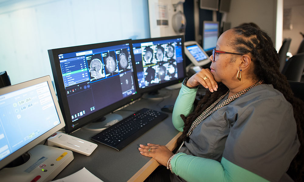 An MRI technologist views images on a screen An MRI technologist views images on a screen