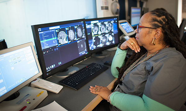 An MRI technologist views images on a screen An MRI technologist views images on a screen