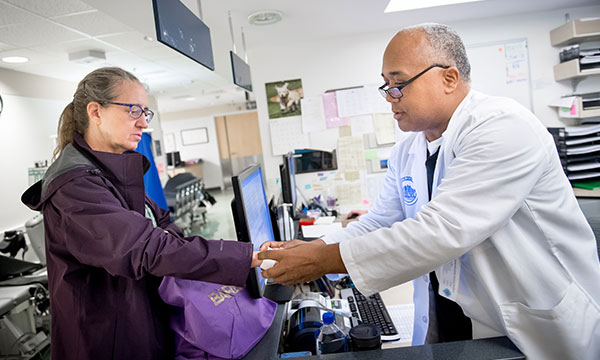A care coordinator checks in a patient. A care coordinator checks in a patient.