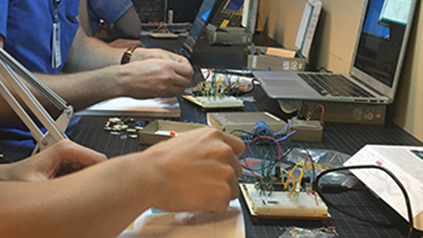 Students adjust wires connected to computers Students adjust wires connected to computers