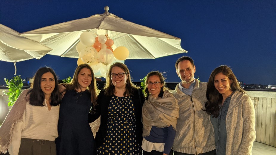 People posing on a rooftop patio decorated with balloons. People posing on a rooftop patio decorated with balloons.