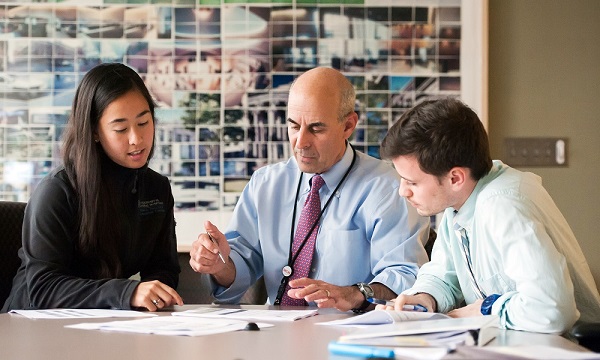 MPEC Director Kenneth Freedberg, MD, consults with team members. MPEC Director Kenneth Freedberg, MD, consults with team members.