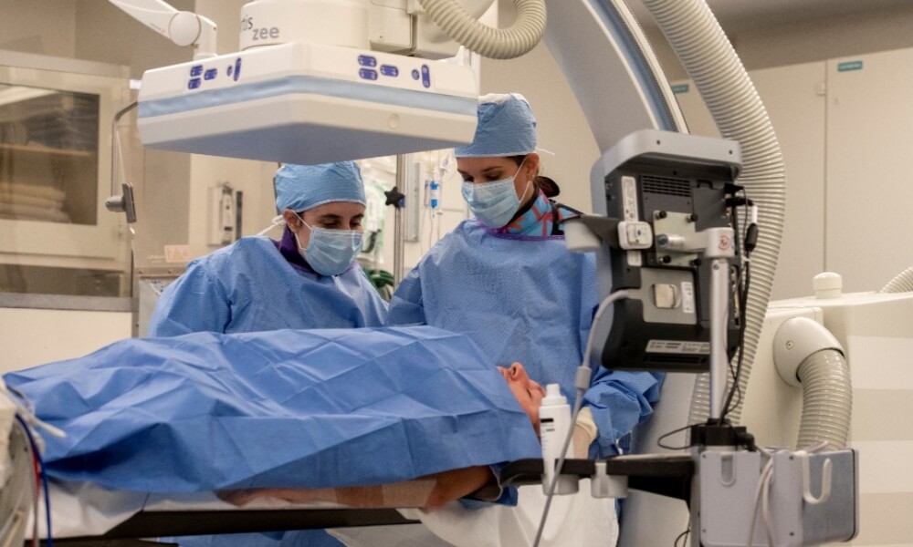 Two physicians with a patient Two physicians with a patient