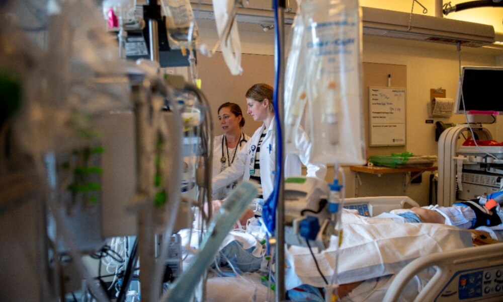 Two physicians with a patient Two physicians with a patient