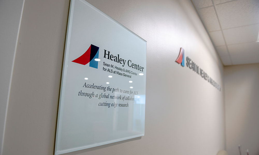 A sign at the Sean M. Healey & AMG Center for ALS at Mass General, displaying the center name and logo. A sign at the Sean M. Healey & AMG Center for ALS at Mass General, displaying the center name and logo.