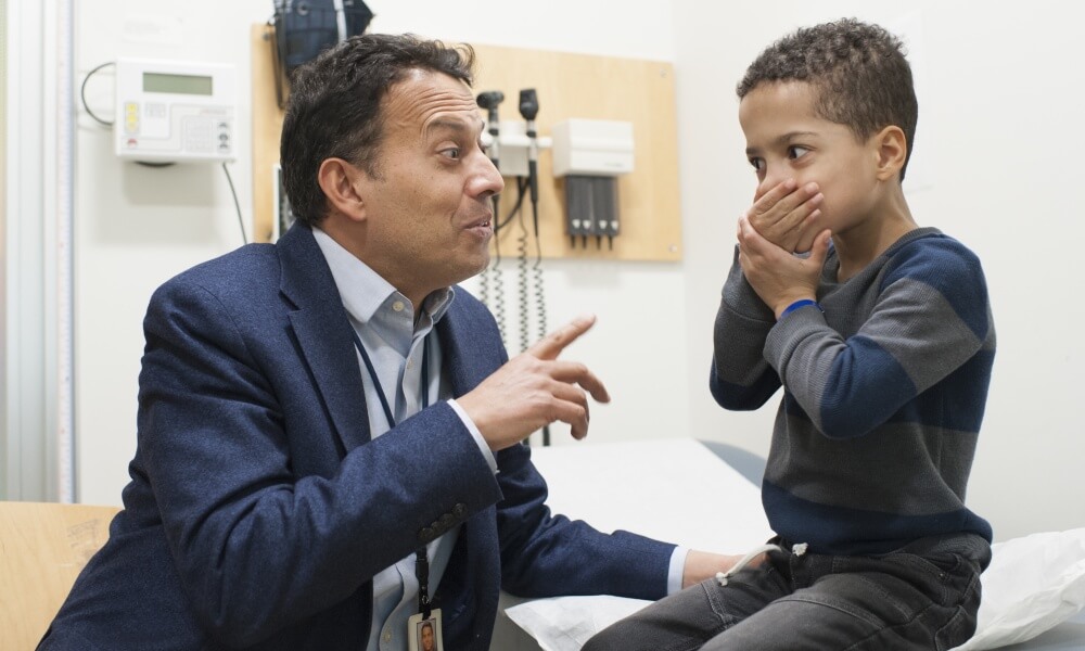 Dr. Eichler and a young patient smiling Dr. Eichler and a young patient smiling