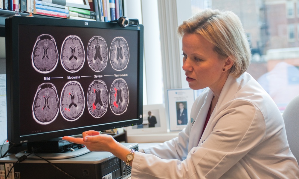 Dr. Rost looking at brain imaging slides Dr. Rost looking at brain imaging slides