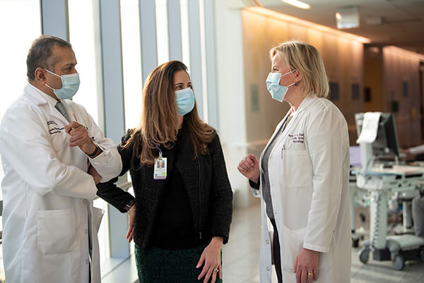 Dr. Singhal, Rost and Camargo-Faye discuss a case.