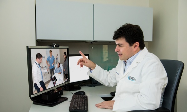Dr. Eric Rosenthal consults with a patient by videoconference Dr. Eric Rosenthal consults with a patient by videoconference