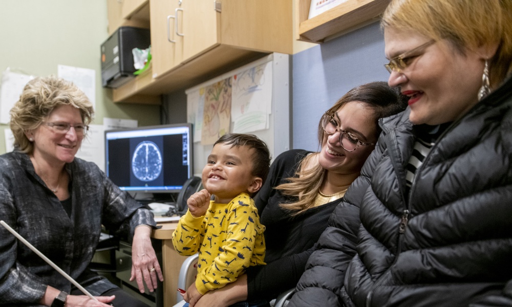 Dr. Thiele talks with two women and a baby Dr. Thiele talks with two women and a baby