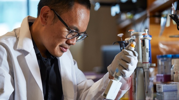 Research Fellow Aloysius Domingo, MD with a pipette filler Research Fellow Aloysius Domingo, MD with a pipette filler