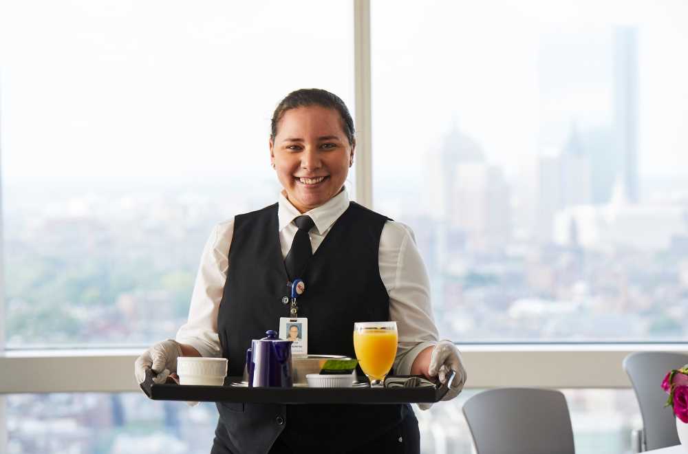 Staff member with a tray of food Staff member with a tray of food