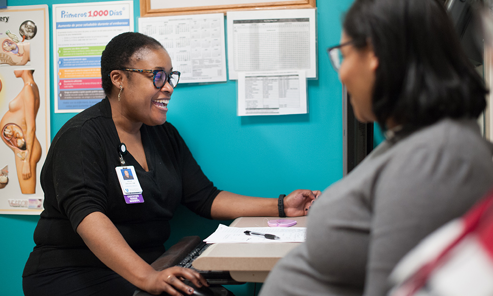 Nurse speaking with a patient Nurse speaking with a patient