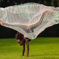 image of a child flying a kite in a field