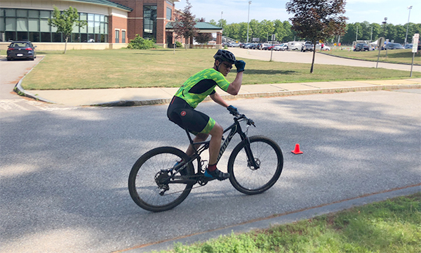 A bicyclist in racing gear. A bicyclist in racing gear.