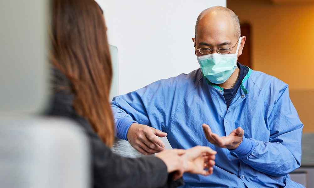 Neal Chen, MD, Chief of the Hand & Arm Service, speaks with a patient. Neal Chen, MD, Chief of the Hand & Arm Service, speaks with a patient.
