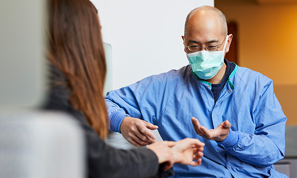 Neal Chen, MD, Chief of the Hand & Arm Service, speaks with a patient. Neal Chen, MD, Chief of the Hand & Arm Service, speaks with a patient.