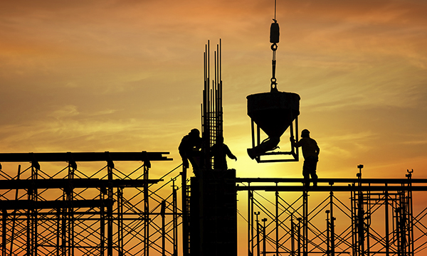 A construction site silhouetted in the sunset A construction site silhouetted in the sunset