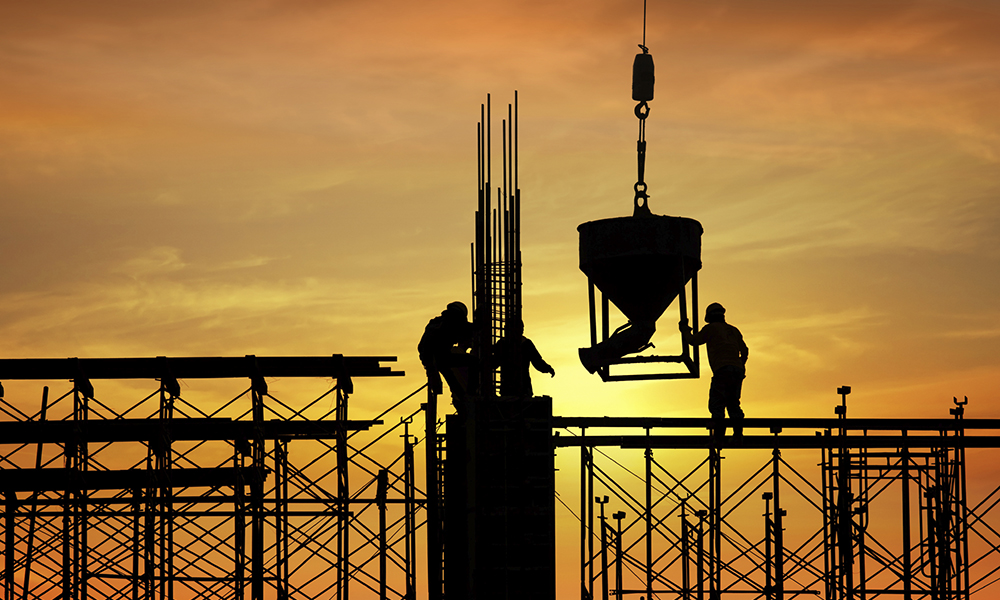 A construction site silhouetted in the sunset A construction site silhouetted in the sunset
