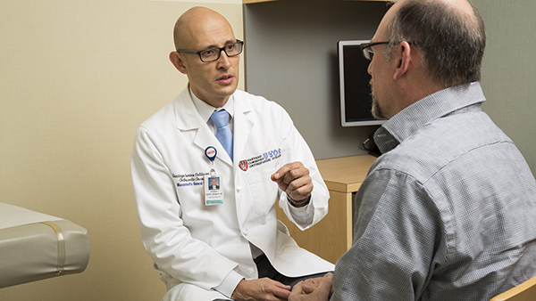 Dr. Santiago Calderon with a patient Dr. Santiago Calderon with a patient