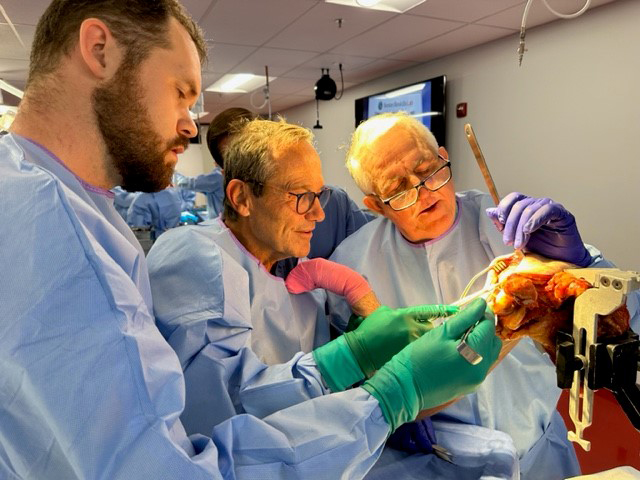 a sports medicine fellow, Dr. Giles Walch and Dr. Gus Mazzocca in the cadaver lab