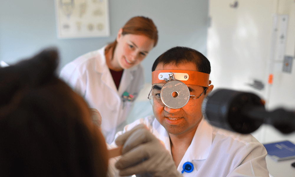 A Massachusetts Eye and Ear Infirmary doctor examines a patient A Massachusetts Eye and Ear Infirmary doctor examines a patient