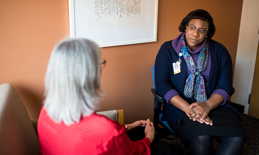 Dr. Olivia Okereke speaks with a patient. Dr. Olivia Okereke speaks with a patient.