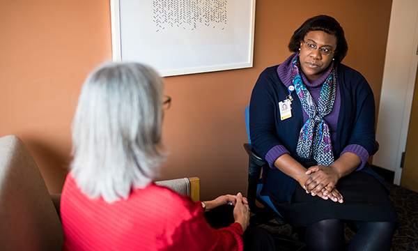 Dr. Olivia Okereke speaks with a patient. Dr. Olivia Okereke speaks with a patient.