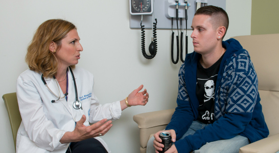 A staff member speaks with a client.  A staff member speaks with a client.