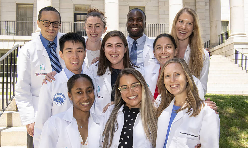 Surgery residents smile outside a building Surgery residents smile outside a building