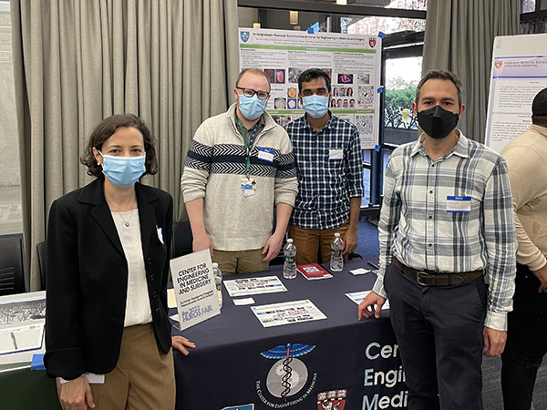 4 individuals in a photo at a fair booth