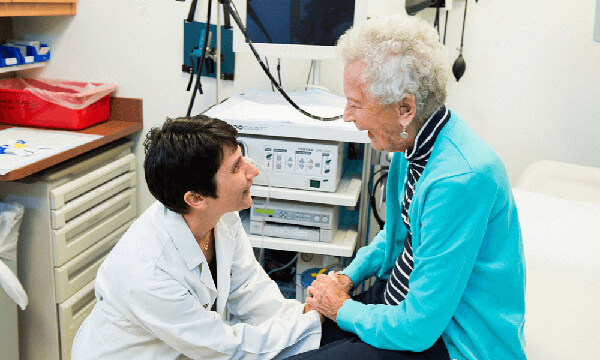 Dr. Bordeianou smiling with a patient Dr. Bordeianou smiling with a patient