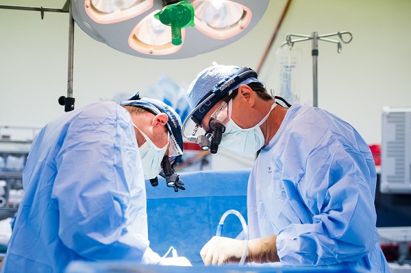 Dean Donahue, MD (right), and Eric Feins, MD (left), perform a complex surgery for a patient with thoracic outlet syndrome. Dean Donahue, MD (right), and Eric Feins, MD (left), perform a complex surgery for a patient with thoracic outlet syndrome.