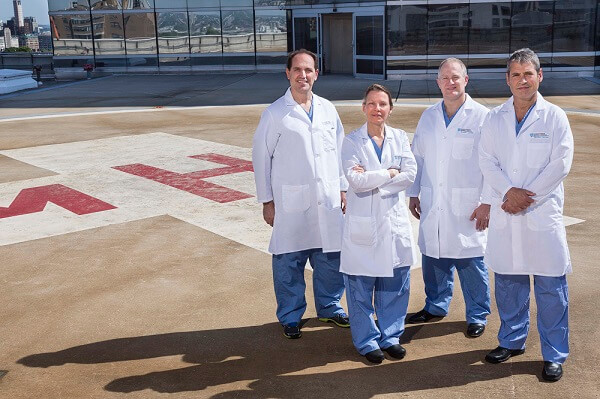 George Velmahos, MD; Tina Duhaime, MD; David Brown, MD; and Mark Vrahas, MD, on the Mass General helipad George Velmahos, MD; Tina Duhaime, MD; David Brown, MD; and Mark Vrahas, MD, on the Mass General helipad