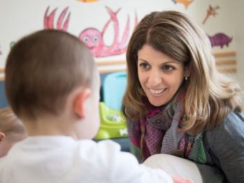 A smiling woman with a toddler