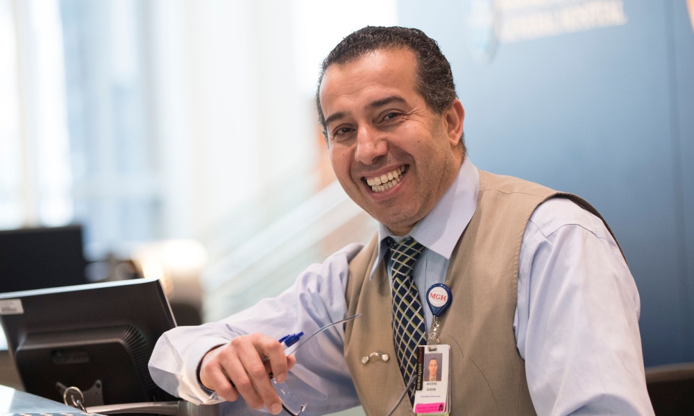 Smiling man at info desk Smiling man at info desk